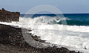 Rough surf  at edge of black sands of Pohoiki  beach