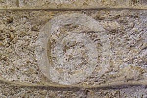Rough surface of an old stone wall close-up. Texture background or backdrop