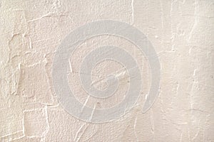 Rough surface plaster texture. Peachy pink light orange color background with copy space. Decorative plastering textured photo