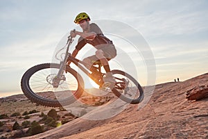 Rough terrain is nothing to him. Full length shot of a young male athlete mountain biking in the wilderness.