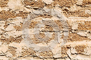 Rough texture of a brick wall made of shells