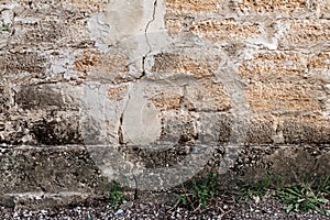Rough texture of a brick wall made of shells. There is a crack in the middle of the wall