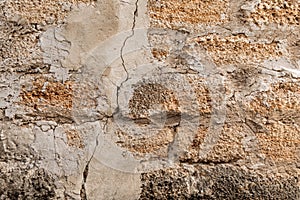Rough texture of a brick wall made of shells. There is a crack in the middle of the wall