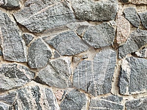 Rough texture old granite stone wall