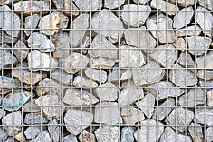 Rough textured wall with nature stones and a metal wired frame, Koekelberg, Belgium