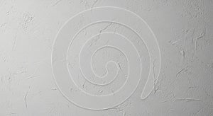 Rough-textured white stucco wall with visible cracks and imperfections. The surface