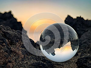 Rough Volcanic landscape at sunset with lensball