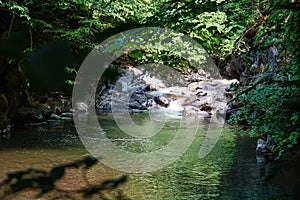 Rough water in the mountains, water flows over the rocks, forest, nature, mountains, waterfall, background