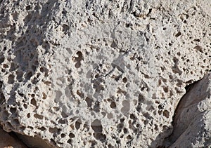 Rough weathered sandstone surface texture close up