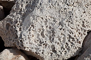 Rough weathered sandstone surface texture close up