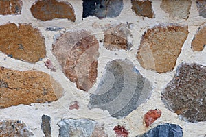 Rough weathered stone wall surface texture close up