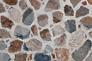 Rough weathered stone wall surface texture close up