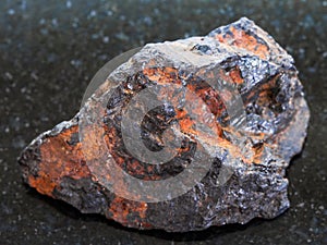 rough Wolframite stone (tungsten ore) on dark