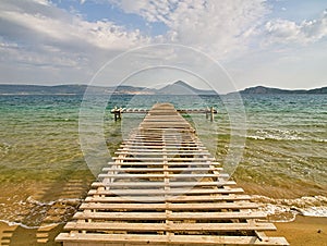 Rough wooden pier, over sea water, Gialova lagoon, Peloponnese, Greece