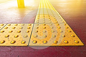 Yellow dot tactile paving for blind handicap on tiles pathway in japan, walkway for blindness people