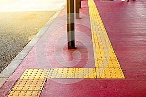 Yellow dot tactile paving for blind handicap on tiles pathway in japan, walkway for blindness people photo