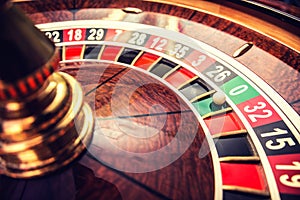 Roulette wheel in casino with ball on green position zero