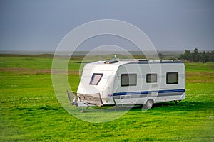 Roulotte on the countryside of Iceland, summer season, white caravan