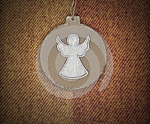 Round angel pendant on brown cashmere textile background