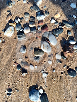 Round, angular,elliptic, colourful stone and sea sand