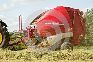 A round baler making hay bale bales during harvesting