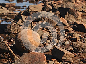 Round ball shaped granite rock at Kattegat sea shoreline in Halmstad, Sweden