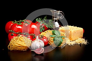 Round balls of pasta with cheese,tomatoes,basil,olive oil on black