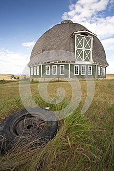 Round barn and tire in foreground.