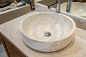 Round bathroom sink on marble stone surface