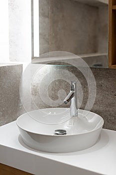 Round bathroom sink in modern bathroom