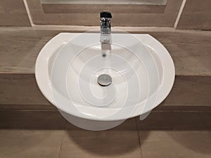 Round bathroom washing sink on marble stone surface