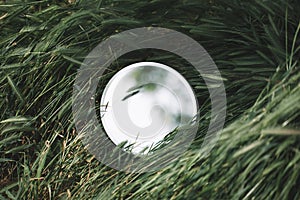 Round beautiful glass in the grass