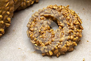 Round biscuits glazed with chocolate with nuts. Chocolate cookies