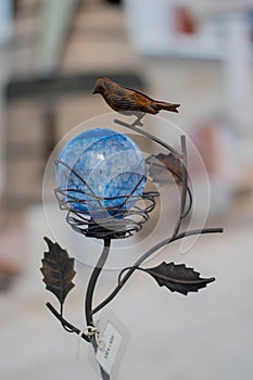 round blue globe and metal bird