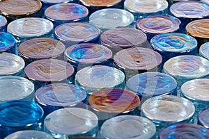 Round blue iridescent glass tiles in a row at and angle