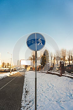 Round blue sign Pedestrian and Bicycle path close-up. A sign that divides the path for pedestrians and bicyclists.