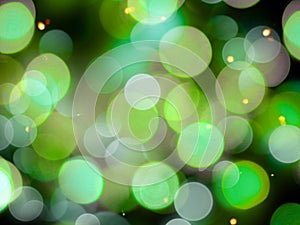 round blurred white and green blurred lights background with yellow sparkle effect