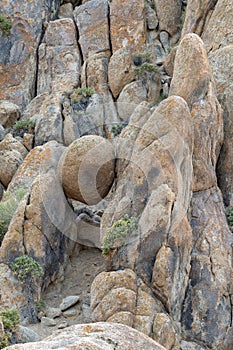 A round boulder suspended between rocks in the Alabama Hills near Lone Pine, California, USA