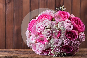 Round bouquet of roses on the background of wooden boards