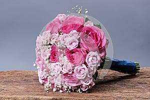 Round bouquet of roses on the background of wooden boards