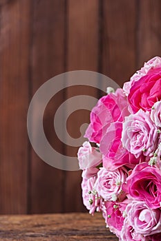 Round bouquet of roses on the background of wooden boards