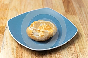 Round bread in blue plate