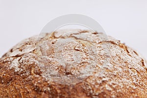 Round bread with a golden crust. White background. Close-up. Space for text