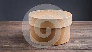 Round brown cardboard box on wooden table. Mock up. Packaging for delivery. Eco package