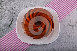 Round cake from almond and rice flour on the striped tea towel