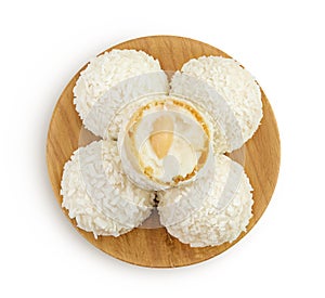 round candy raffaello with coconut flakes and nut in wooden bowl isolated on white background