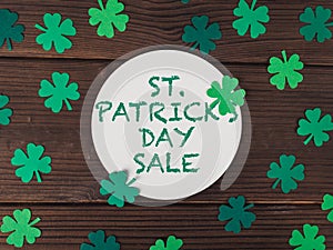 round card with text st patricks day sale on wooden background