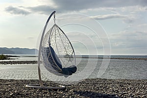 Round chair hammock on the beach