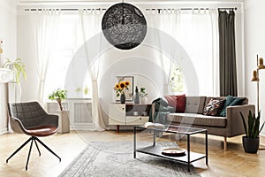 Round chandelier in a retro living room interior