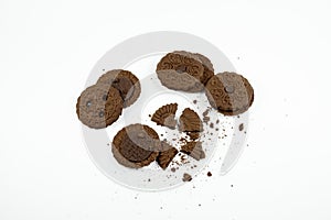 Round chocolate biscuits scattered on a white background